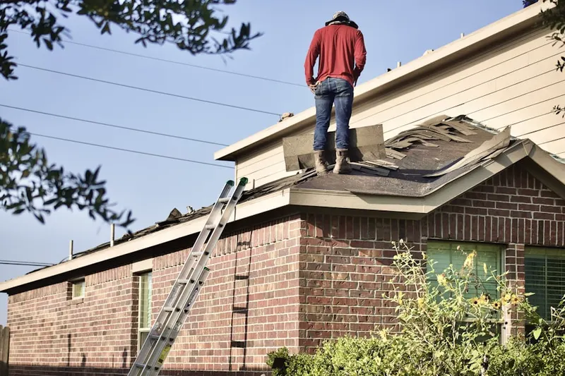 Professional roofer working on a residential roof in East Colfax